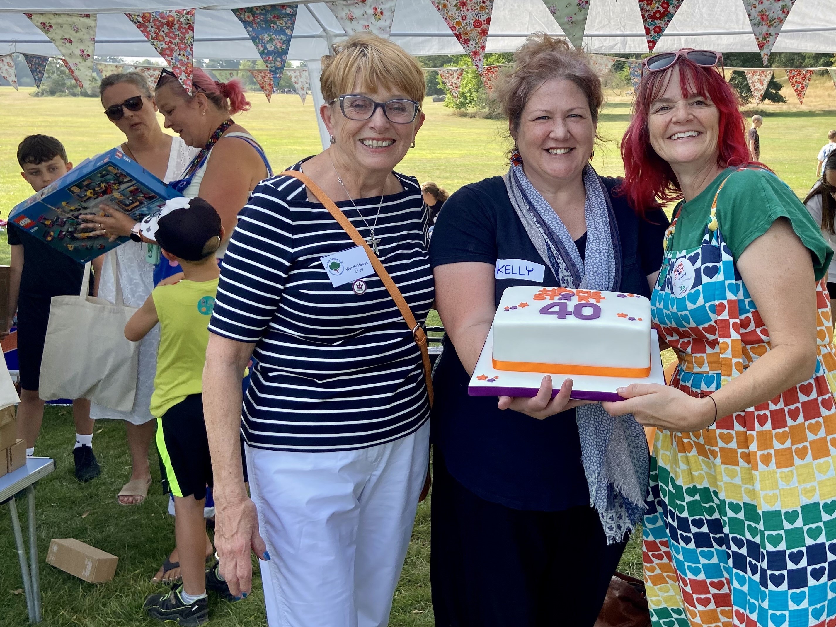 Reading Family Aid team and Kelly with the cake