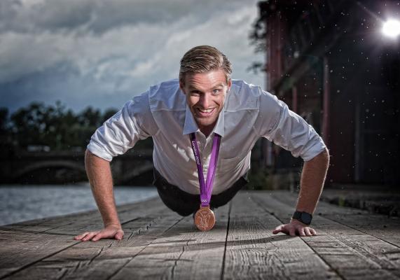 Alan Campbell doing a press up in shirt and tie