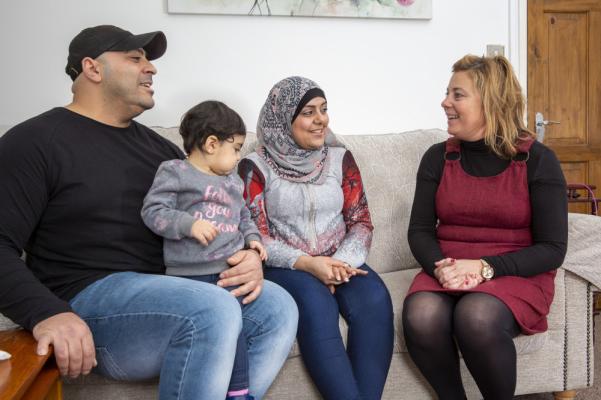 A volunteer talking to a family